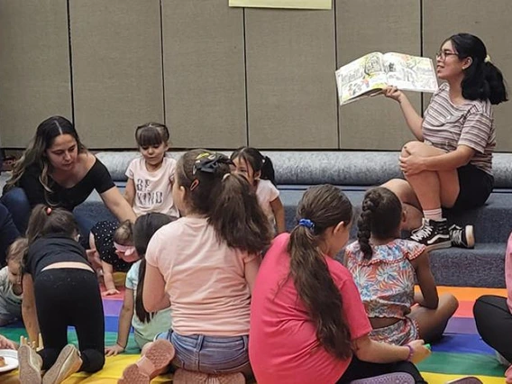 teacher reading to a group of kids