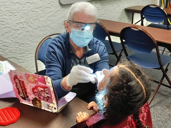 Photo of a woman giving a dental exam