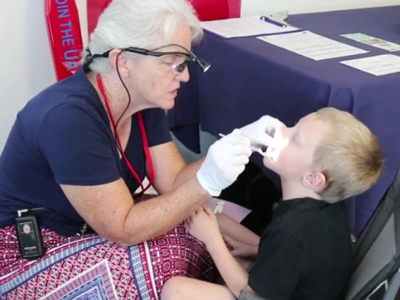 Dentist inspecting a kids mouth