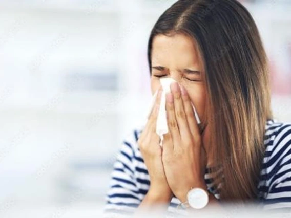 Photo of a woman sneezing