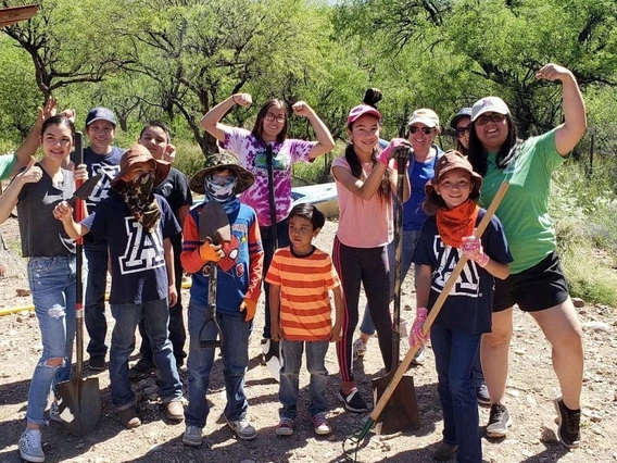 4-H leaders and kids in garden