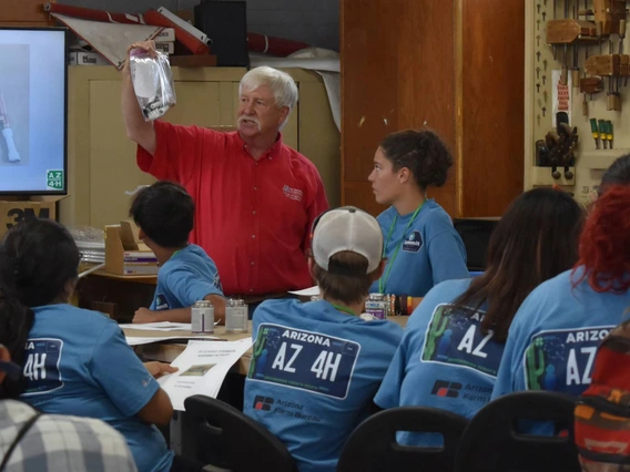 4-H volunteer presenting to youth