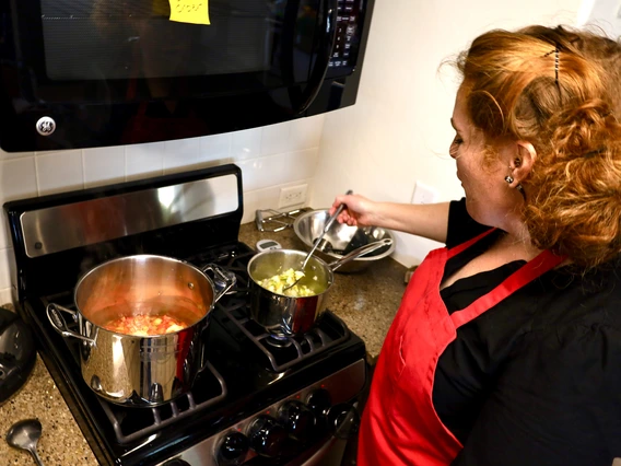 stiring soup on the stove