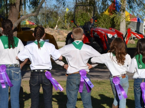 4-H kids linking arms with ribbons in pocket