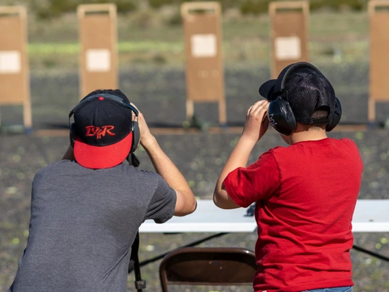 4-H youth inspecting shooting sports targets