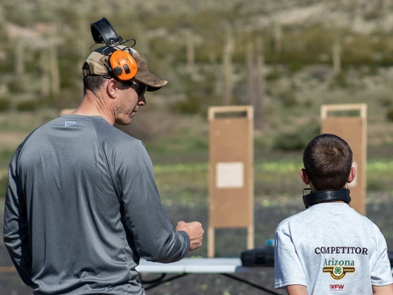 4-h volunteer encouraging youth shooting sprots