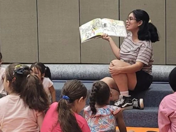 instructor reading to group of young children