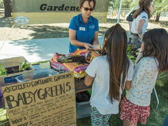 master gardener educating kids at event