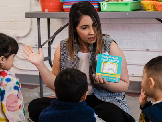 instructor leading reading class for young kids