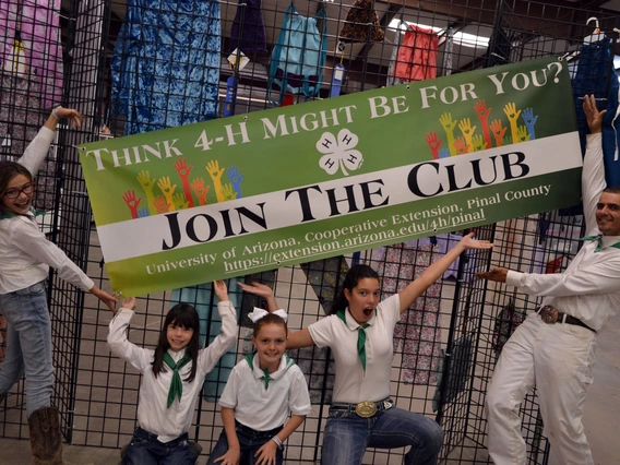 4-h youth in front of club banner