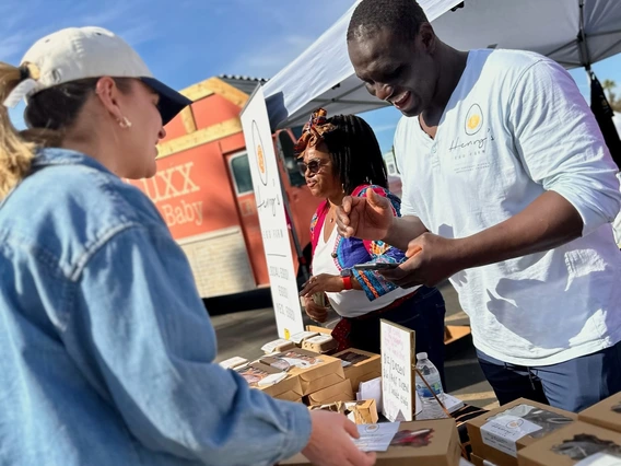 Photo of Henry Osineke Eziama selling eggs at a farmers market