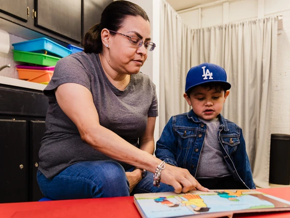 Photo of a woman reading with a toddler