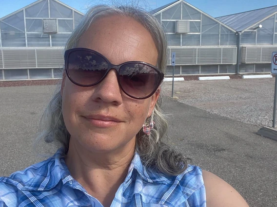 Standing in front of the University of Arizona greenhouses in Tucson