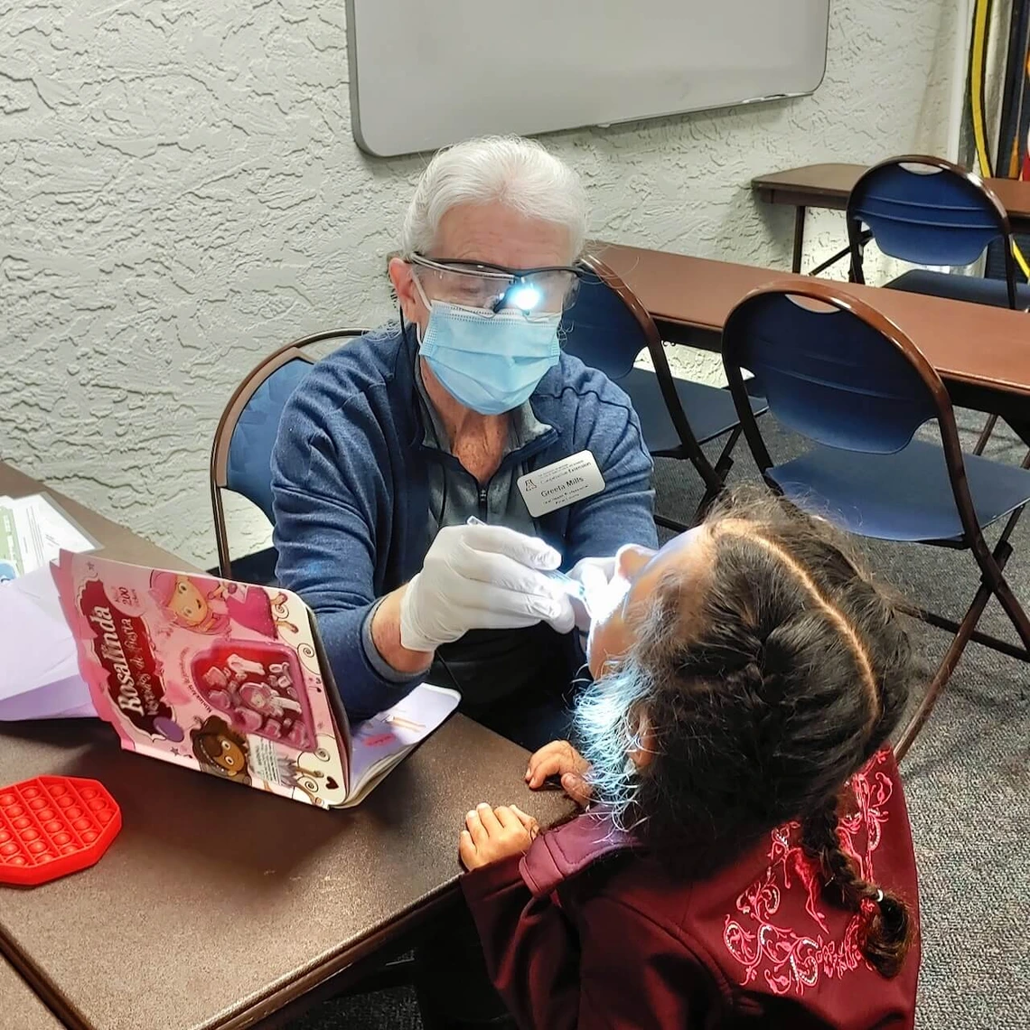 Photo of a woman giving a dental exam