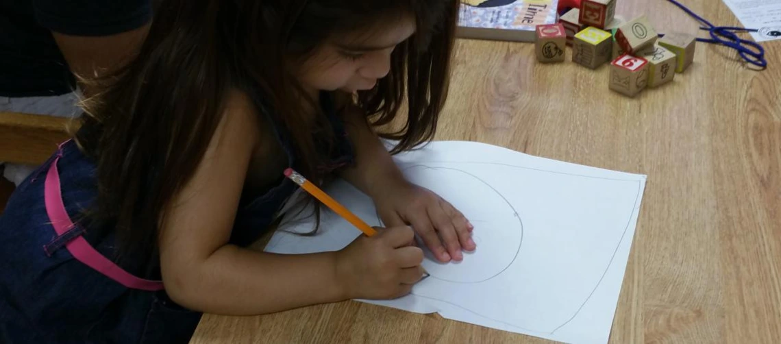 child draws on paper