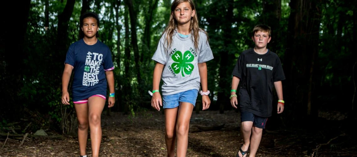 4-h youth walking in forest