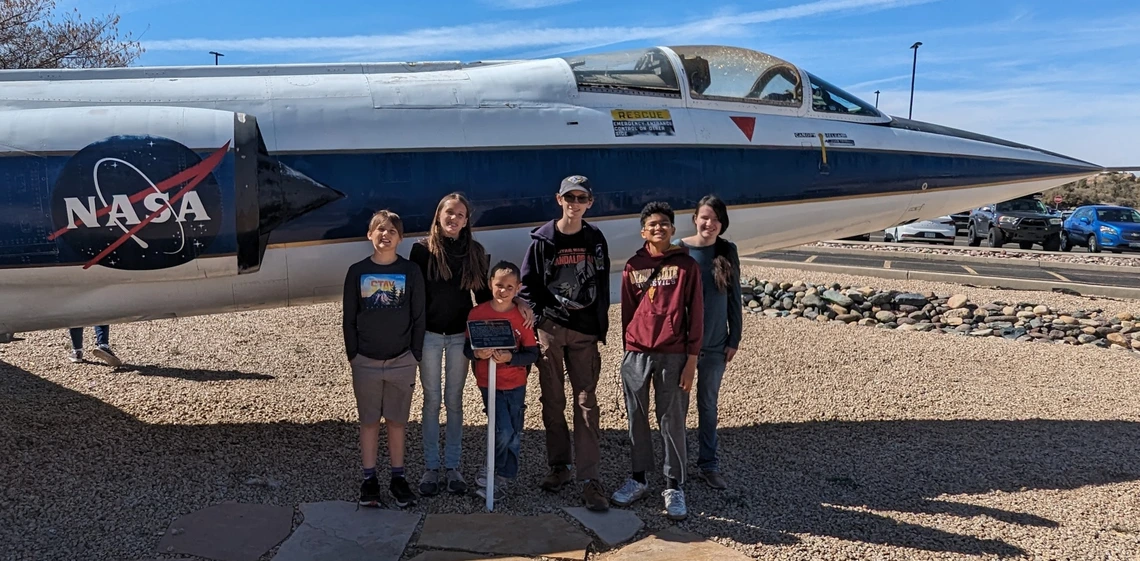 4-H youth in front of NAZA jet