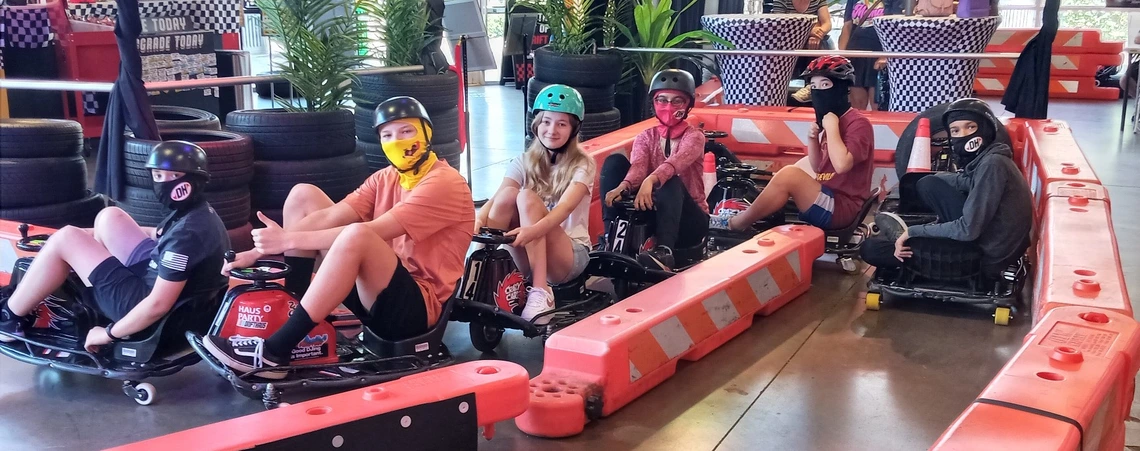 young kids in go carts posing for photo