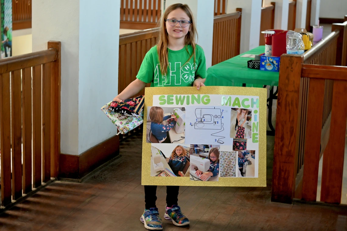 Girls showing off her fair exhibit
