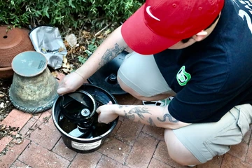 Photo of researcher checking a mosquito trap