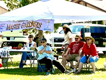 Elderly Master Gardeners sitting at Mohave Master Gardener booth