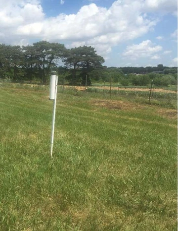 ETgage on pole in a field of grass