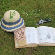 Hat on grass with pruning tool