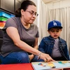 Photo of a woman reading with a toddler
