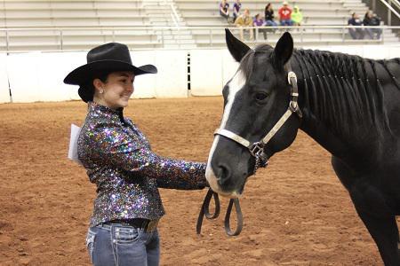 female 4-H member holding horse for halter contest